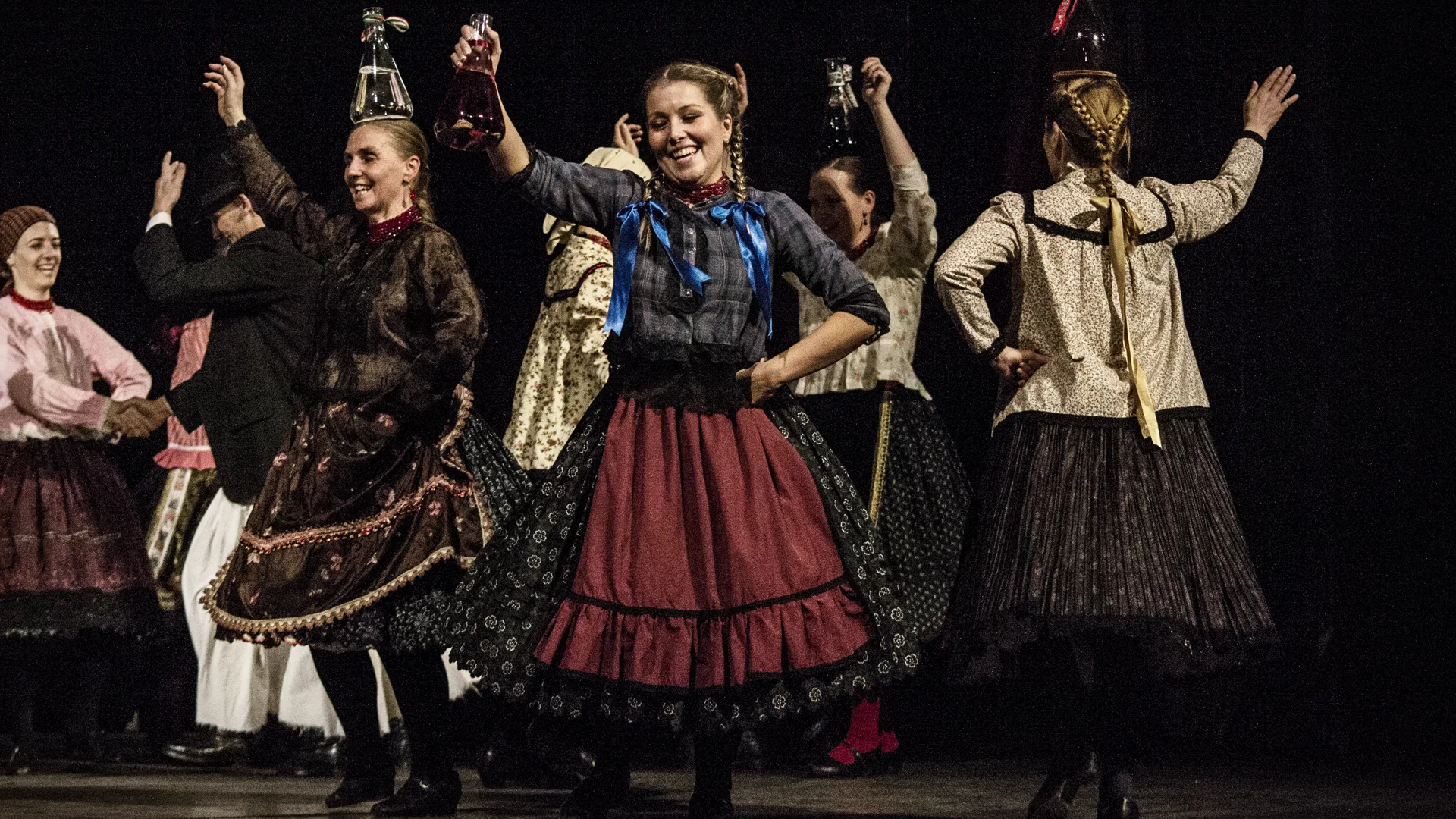 Hungarian folk dancers in traditional costume performing on stage